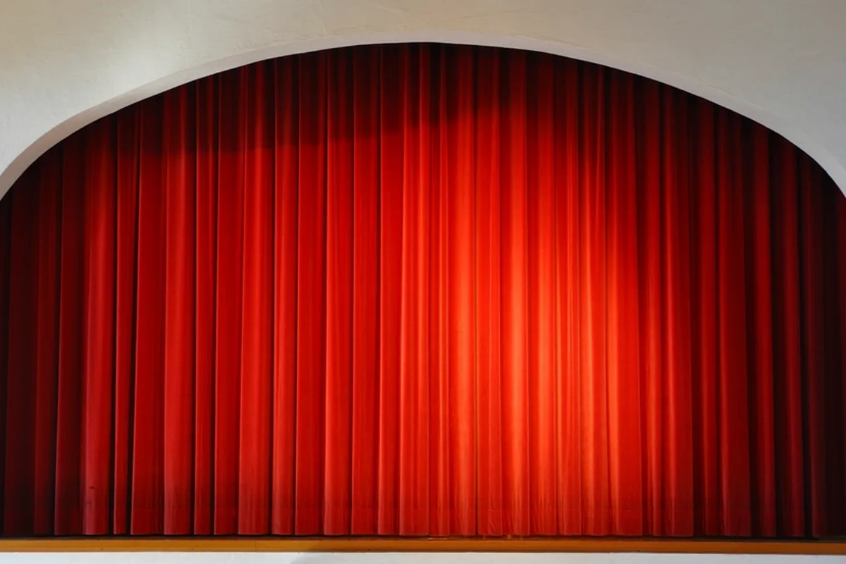 A red curtain on a theatre stage